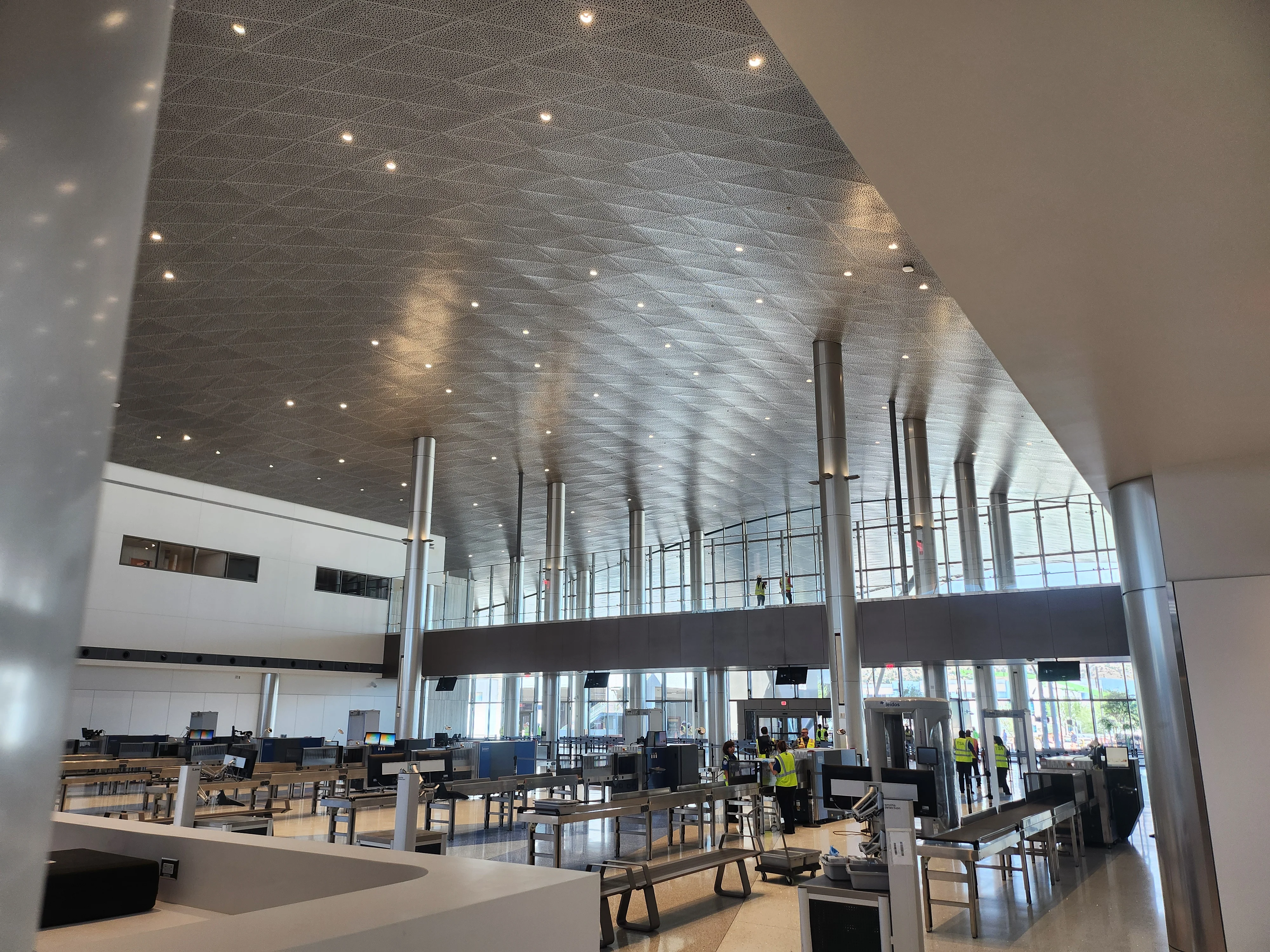 A wide view of the new TSA security screening hall, with scanners and ample open space